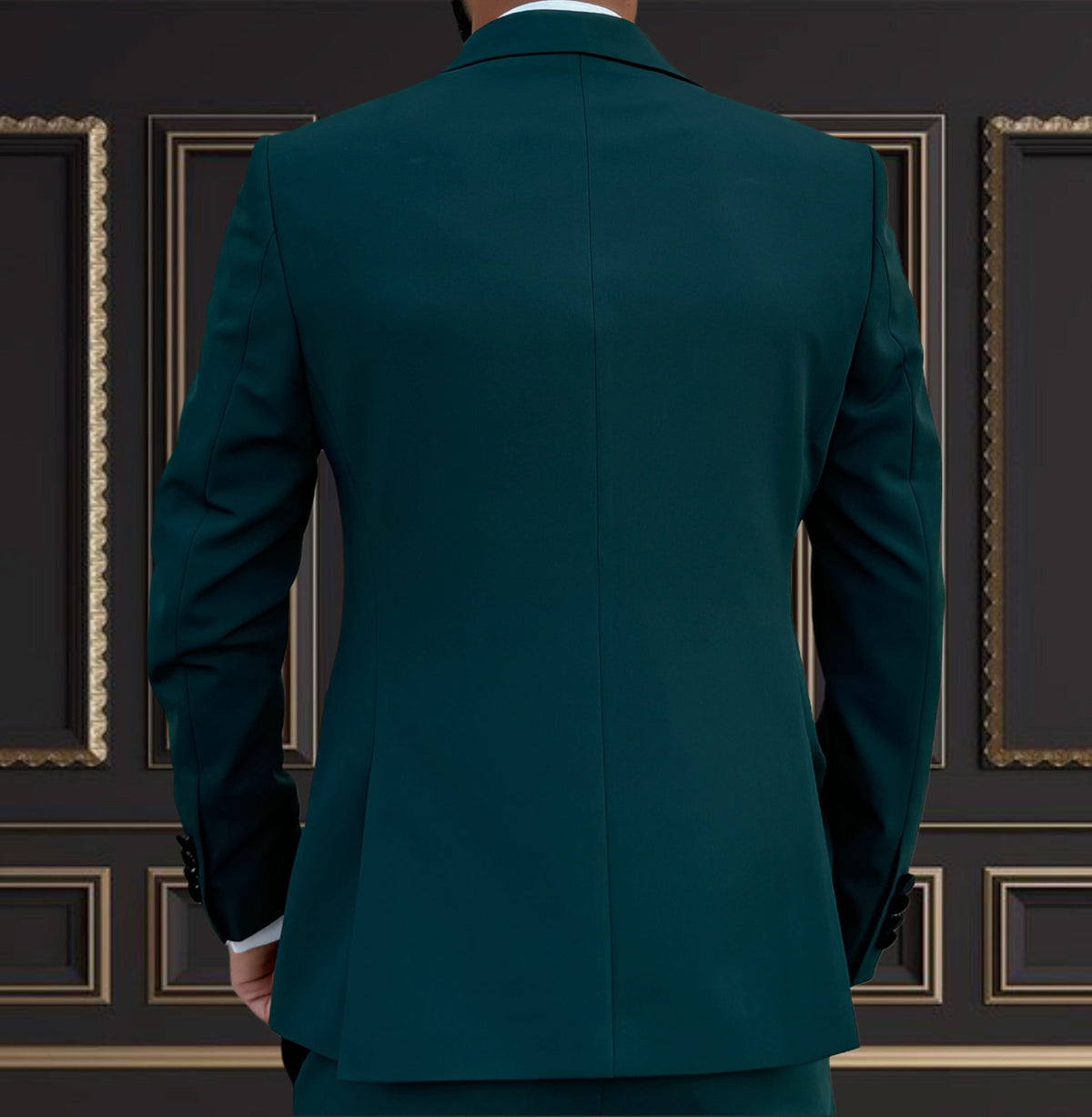 Back view of a men's emerald green tuxedo with velvet peak lapel, perfect for formal events and weddings.